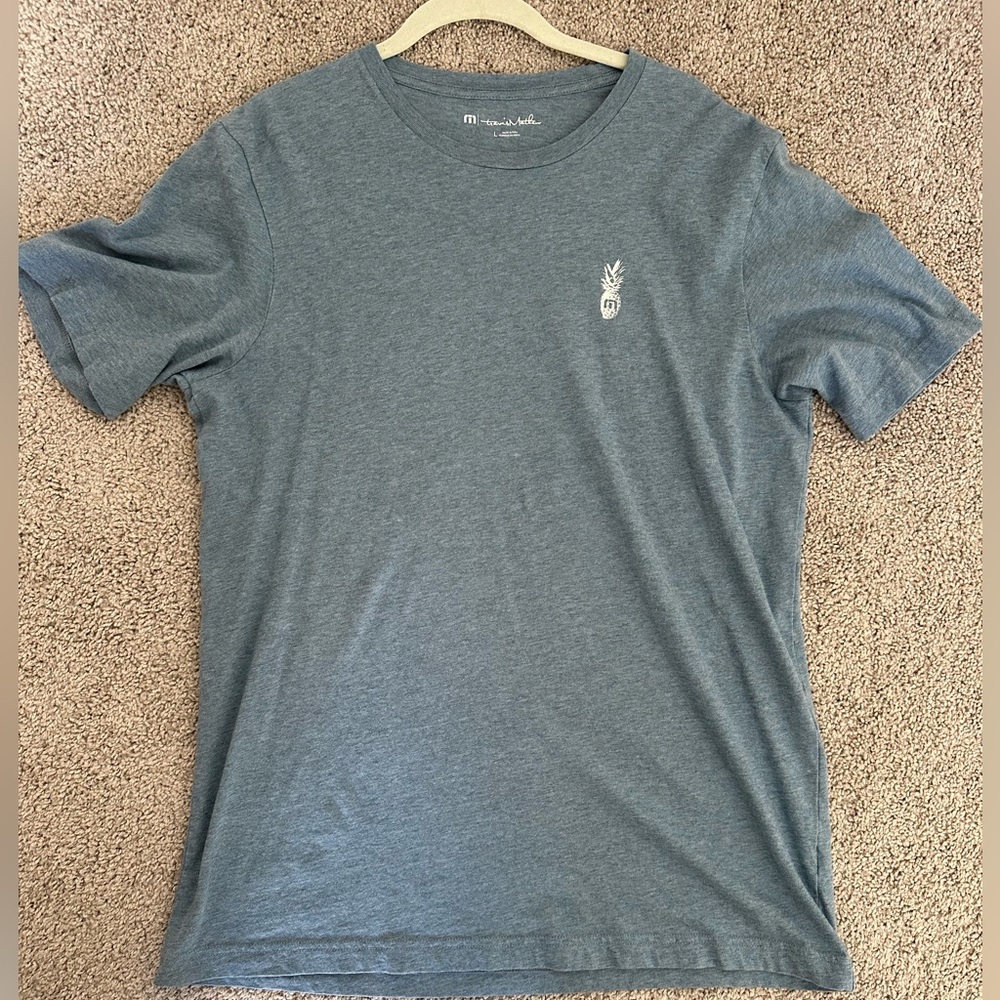 Men’s Travis Matthew light blue tshirt with pineapple detail